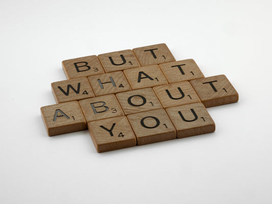 four scrabble tiles spelling out the words but what about you?